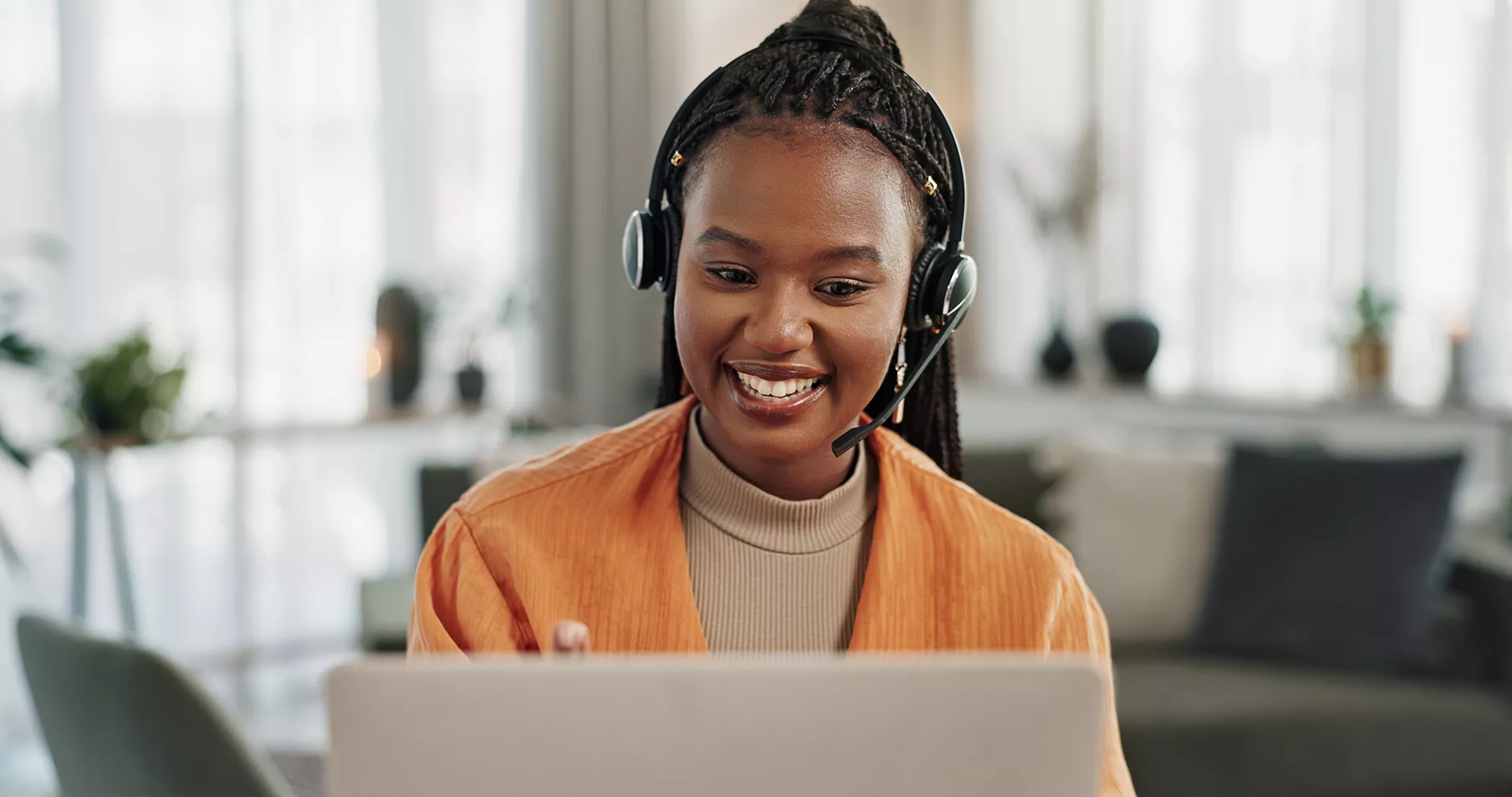 women in headphones using computer